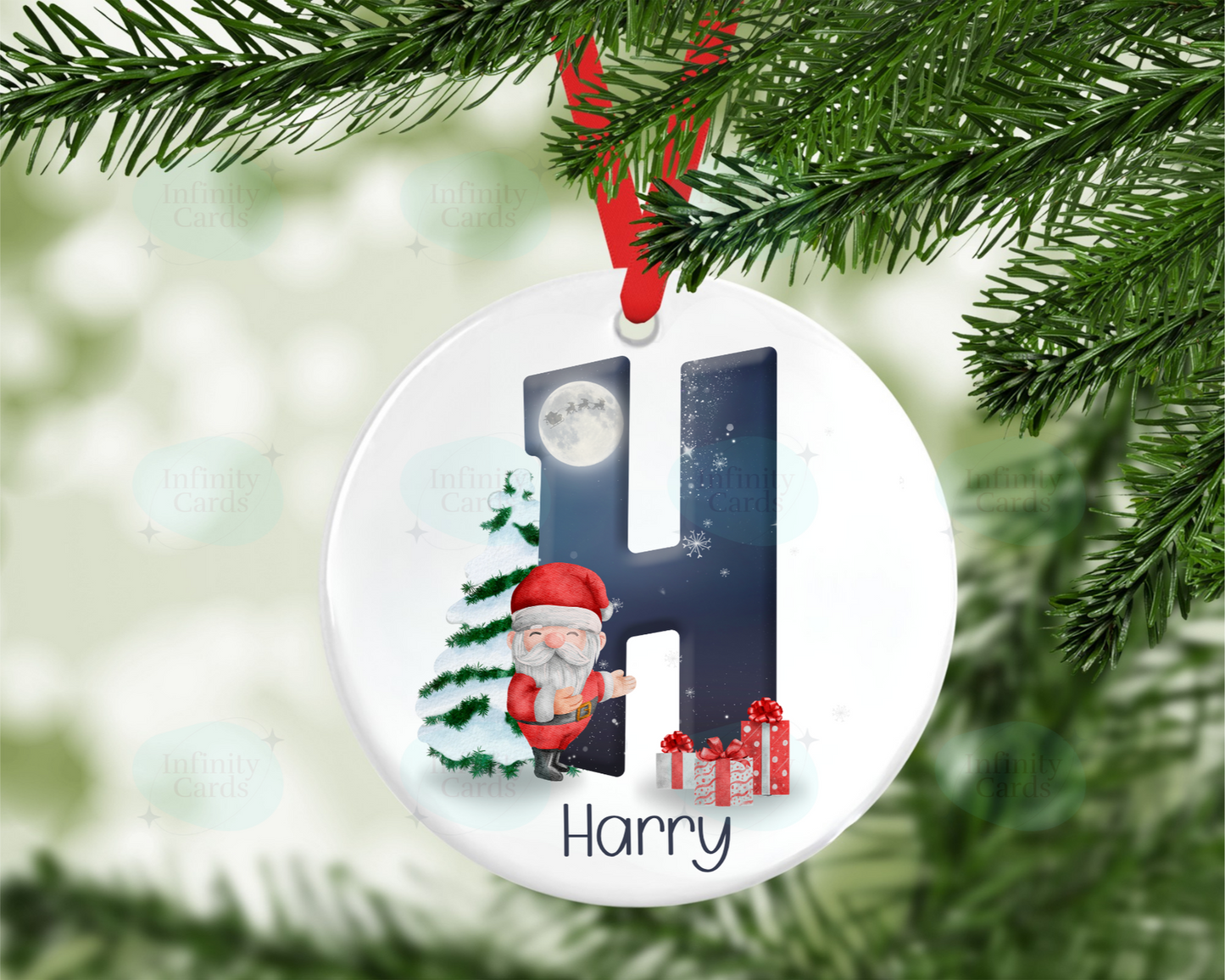 Christmas ornament with letter 'H' and Santa Claus, hanging on a tree.