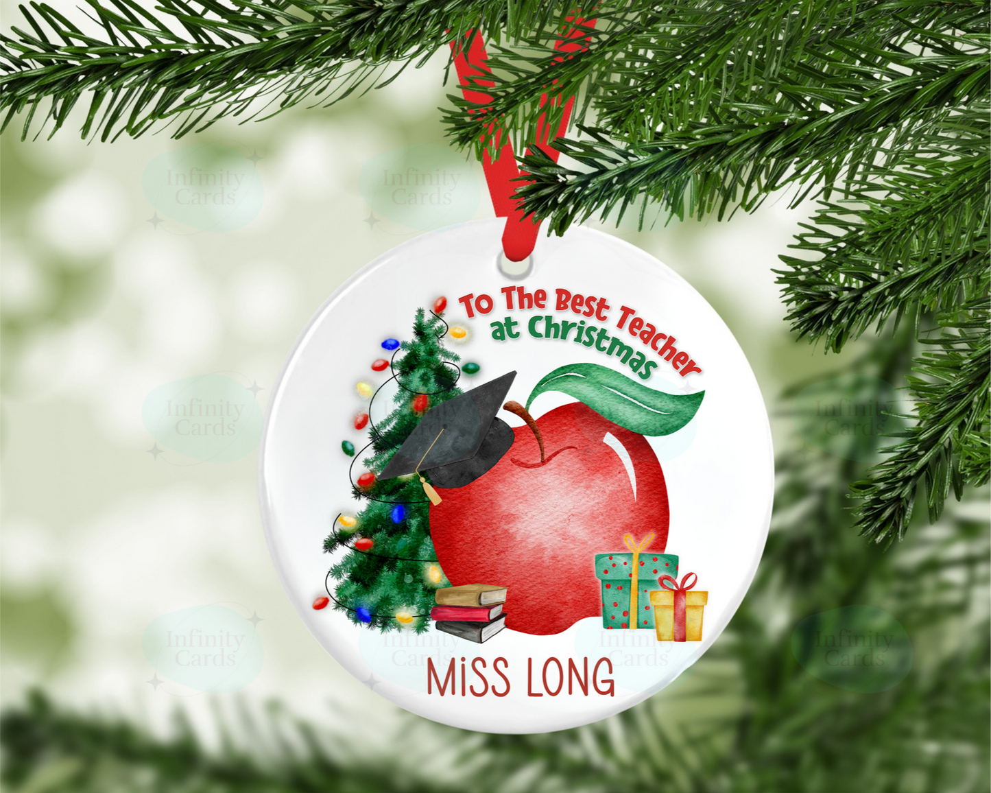 Christmas ornament with a red apple, tree, and books on a white background, hanging from a tree.