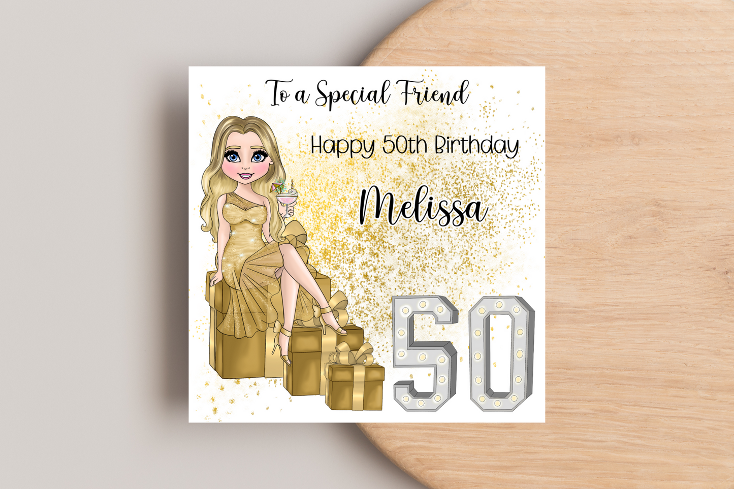 50th Birthday Card Personalised- Customisable Lady in Gold Dress Sitting on Glittering Presents with Age in Light-Up Numbers