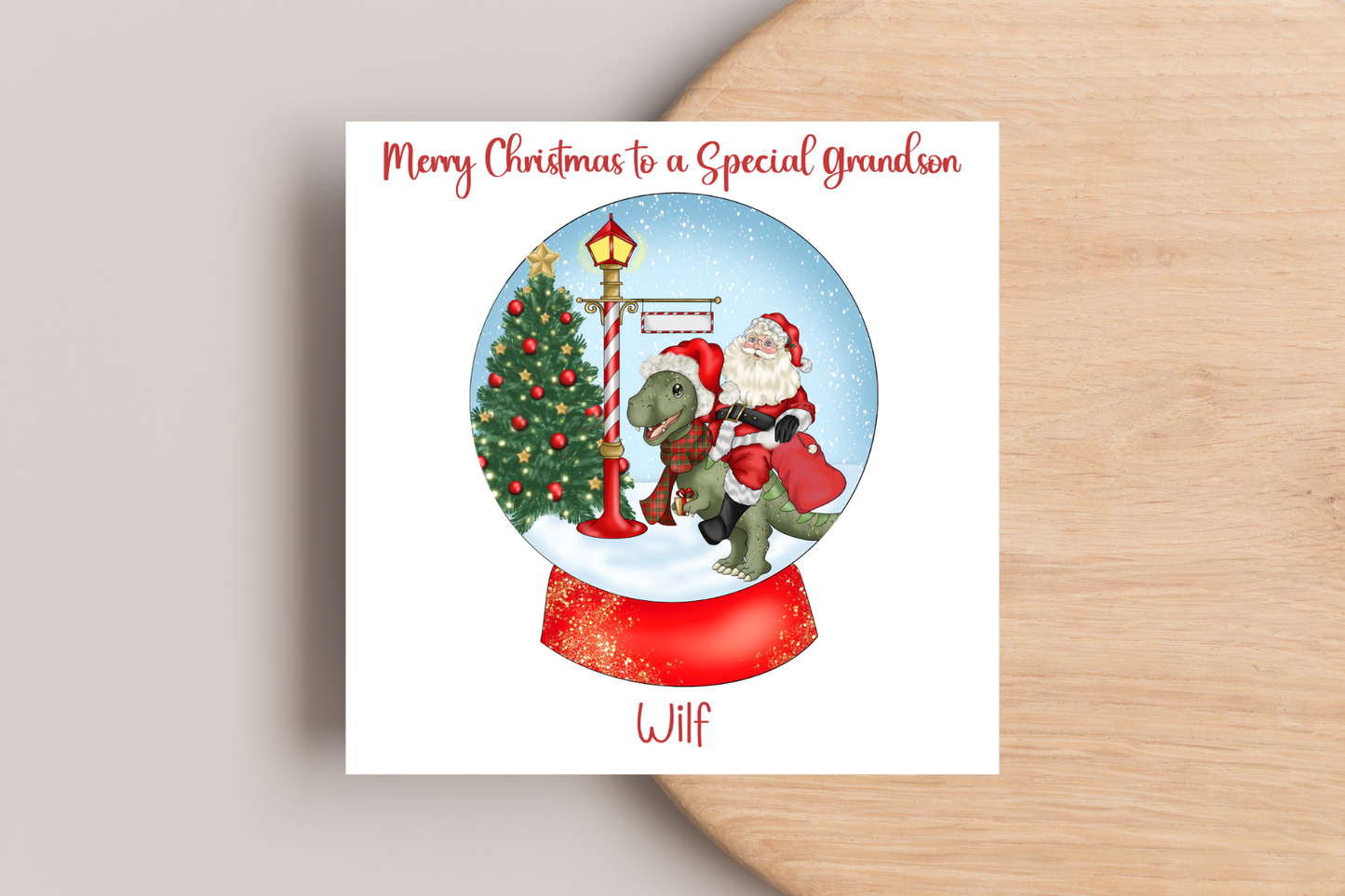 Santa riding a Dinosaur in a Snow Globe Christmas Card