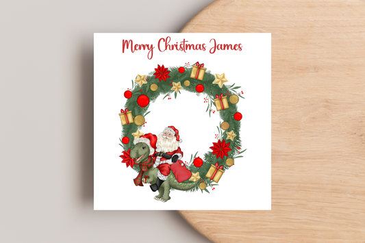 Santa riding a Dinosaur in a Wreath Christmas Card- Personalised