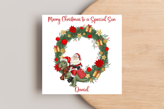 Santa riding a Dinosaur in a Wreath Christmas Card