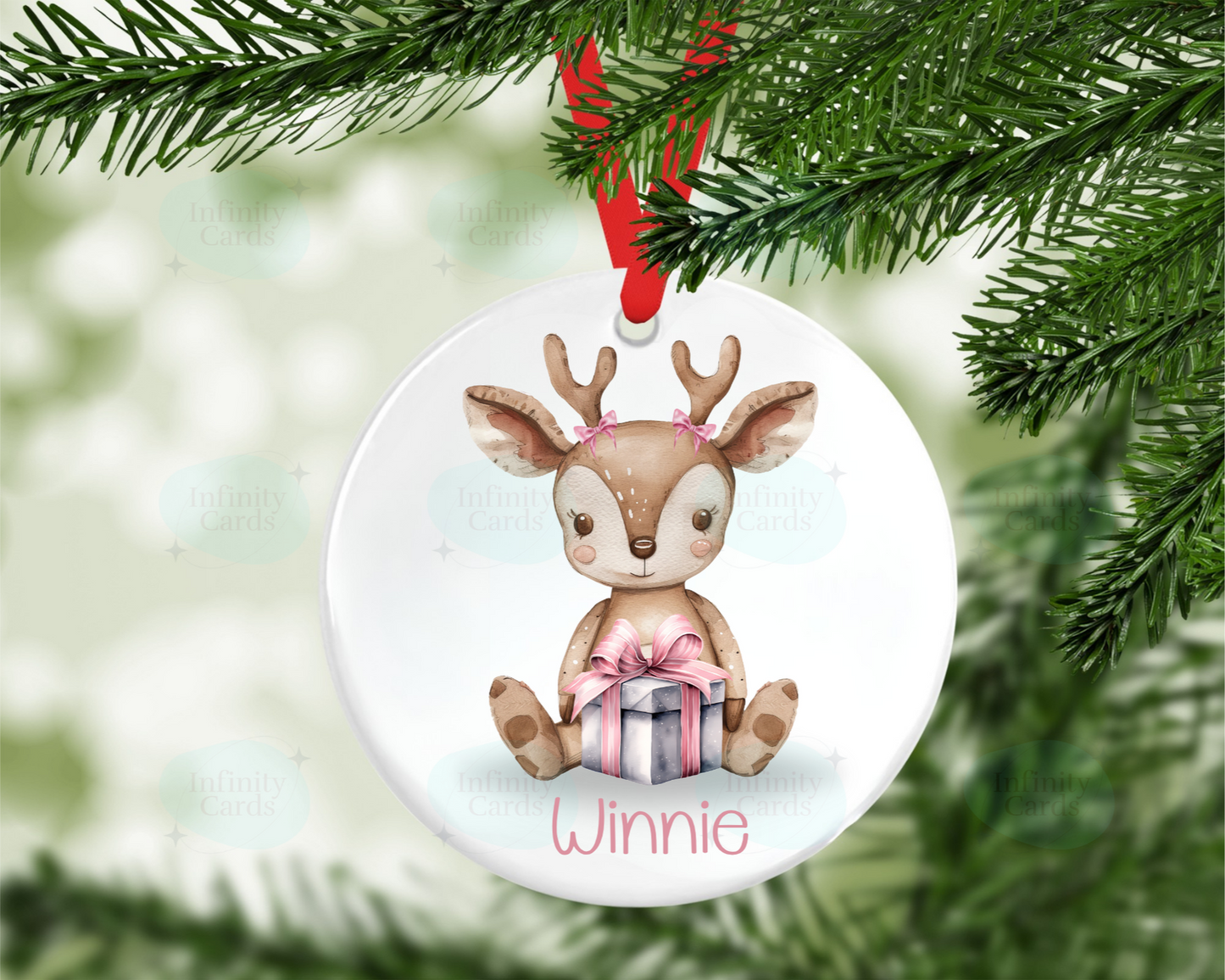 Decorative Christmas ornament with a reindeer holding a gift box, hanging from a tree.
