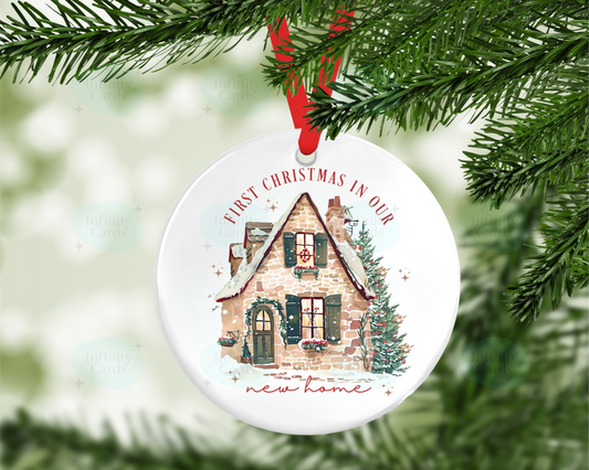 Christmas ornament with a house design and text 'First Christmas in our new home' on a tree.