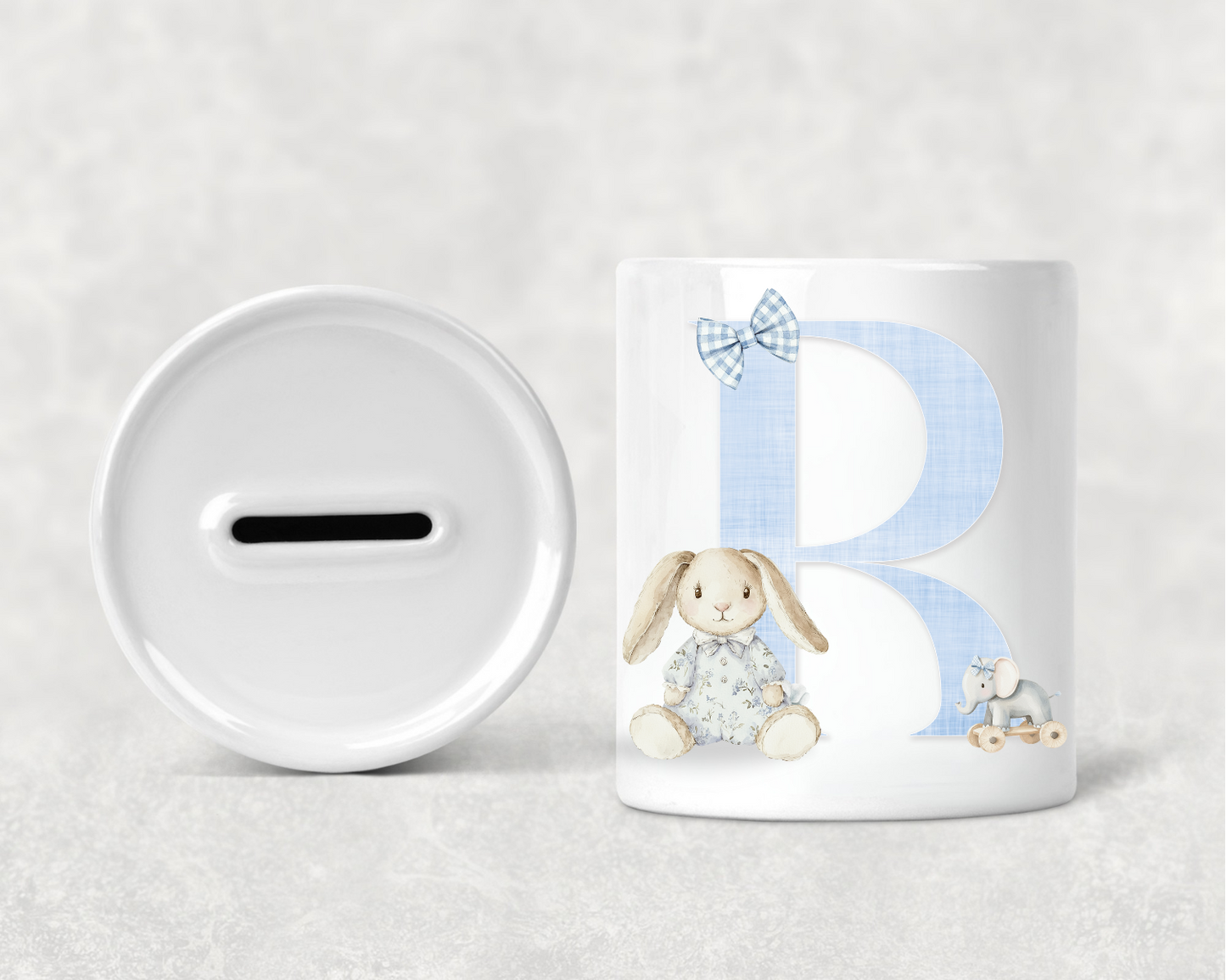 Children's money box and mug with a rabbit design on a light gray background